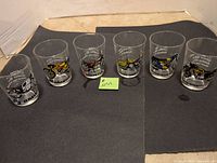 Set of six 5oz clear juice glasses featuring motorcycle brand graphics and colorful illustrations.