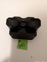 Front view of the black Sawyer View-Master stereo viewer showing the two lenses and central slot.