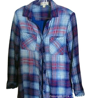 Front view of plaid shirt dress showing color pattern and chest pockets.