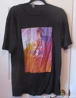 Black T-shirt with full color John Wick 3 movie poster graphic on front.