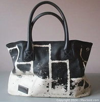 Front view of the tote bag showing black and white abstract Arakawa Alley print and two black handles.