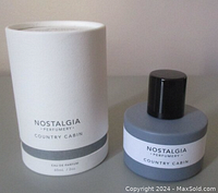 Perfume bottle and packaging box side by side, showing label and design details