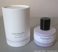 Perfume bottle with packaging showing front label and black cap