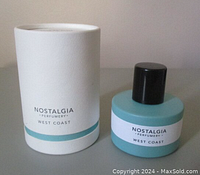 Perfume bottle and box shown horizontal on table, displaying labels and product.