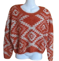 Front view of rusty orange and cream furry sweater with Southwest design on a mannequin showing full length and pattern.