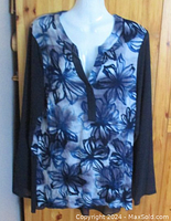 Front view of Simply Vera Wang blouse showing floral front panel and navy blue sleeves.