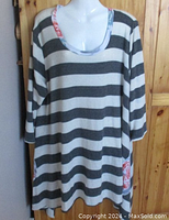 Front view of tea rose striped tunic sweater, showing gray and cream horizontal stripes and floral patches on pockets.