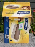 Photo of original yellow packaging box of Broadstone memory foam queen size air bed showing box condition and branding.