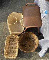 Four baskets and brown padded stool on asphalt surface, showing size and style of each basket and stool