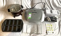 Full set including George Foreman grill, Wilton pan, deep fryer, Pyrex dish and vegetable chopper with attachments.