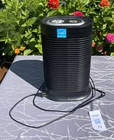Front view showing full Honeywell black air purifier with power cord.