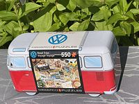 Photo of Volkswagen bus shaped tin with 550 piece Eurographics puzzle labeled Road Trips.
