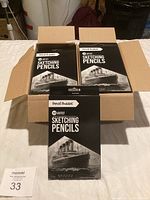 Opened box showing multiple boxes of Pencil Buddies Artist Sketching Pencils, 12 per box.