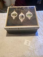 Closed box labeled 'Irish Blessings' with images of three hanging ornaments on lid.