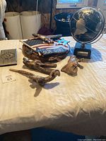 Globe, basket with patriotic decor, and driftwood bird figurines on table