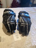 Pair of Easton S5 hockey gloves laid flat on a white surface showing top view and branding