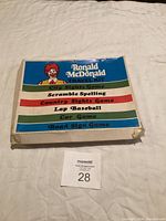 Closed box showing Ronald McDonald Travel Kit with list of included games.