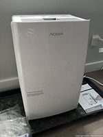 Front and side view of white portable dehumidifier unit