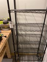 Close-up of the middle shelves and connection points highlighting the adjustable clips and wire shelf design.