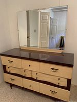 Front view of dresser and mirror against wall