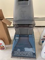 Close-up of Hoover carpet cleaner showing brand and water compartments