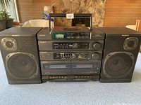 Front view of the Sony CFD-460 shelf stereo system with speakers on either side showing CD player, radio, equalizer, cassette decks, and control buttons