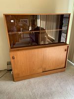 Front view of two-piece hutch showing upper glass display cabinet over lower storage cabinet