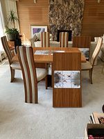 Full set: table with two leaves installed and five chairs arranged around