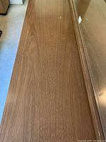 Top surface of the wooden dresser showing wood grain and minor wear.