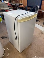 Full view of white Danby bar fridge showing overall shape and power cord.