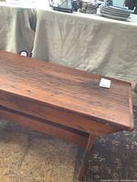Front and side views of a rustic solid pine bench showing wood texture and wear marks.