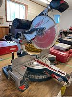 Front-right perspective showing entire saw with base and blade on workbench