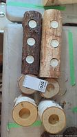 Two long birchwood candle holders with multiple candle slots and three shorter cylindrical holders including one different wood type