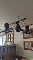 Vintage Harbor Breeze double ceiling fan unit hanging from ceiling, showing two fans and black wire hanging for wiring.