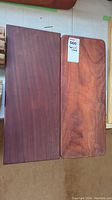 Two rectangular African Paduk wood cutting boards placed side by side, showing wood grain and color variations.