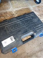 Closed black plastic carrying case with molded 'Mastercraft' logo and blue latches