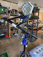 Full view of the Kobalt lighting fixture mounted on adjustable tripod with extendable arm.