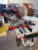 Full overview of saw on wheeled stand in workshop