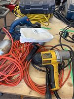 Dewalt impact wrench, Bosch electric planer with bag, and extension cord with trouble lights all visible on workbench