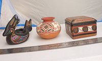 All three pottery pieces side by side with ruler for size reference