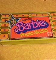 Photo of the exterior box cover showing the Superstar Barbie Photo Studio logo and Mattel brand