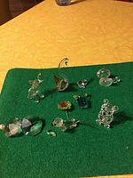 Wide view of all crystal figurines and pieces on green cloth