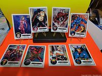 Photo of 9 Marvel Beginnings trading cards arranged on stands and flat, showing various characters and vibrant artwork.