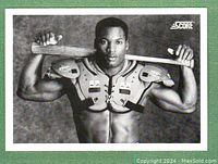 Front side of 1990 Score baseball card showing Bo Jackson holding a bat wearing catcher shoulder pads in a black and white photo.