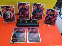 Photo showing seven 2022 Topps Chrome Formula 1 Speed Demons cards featuring images of different drivers in racing gear, vibrant background colors, and Speed Demons branding.