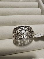 Close-up photo of sterling silver ring featuring an intricate Victorian leaf filigree design. The ring is marked 925 for sterling silver and is displayed on a white ring holder.