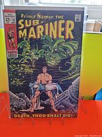 Front cover of Sub-Mariner #13 comic book showing Sub-Mariner holding a woman with sea monsters, including Gargantos, in background