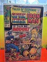 Front cover of Tales of Suspense #94 comic featuring Captain America, Iron Man, and M.O.D.O.K.