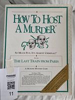 Front of game box showing How To Host A Murder and The Last Train From Paris text.