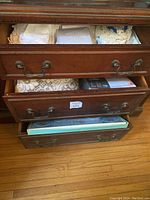 Open dresser drawers showing neatly folded assortment of tablecloths and napkins